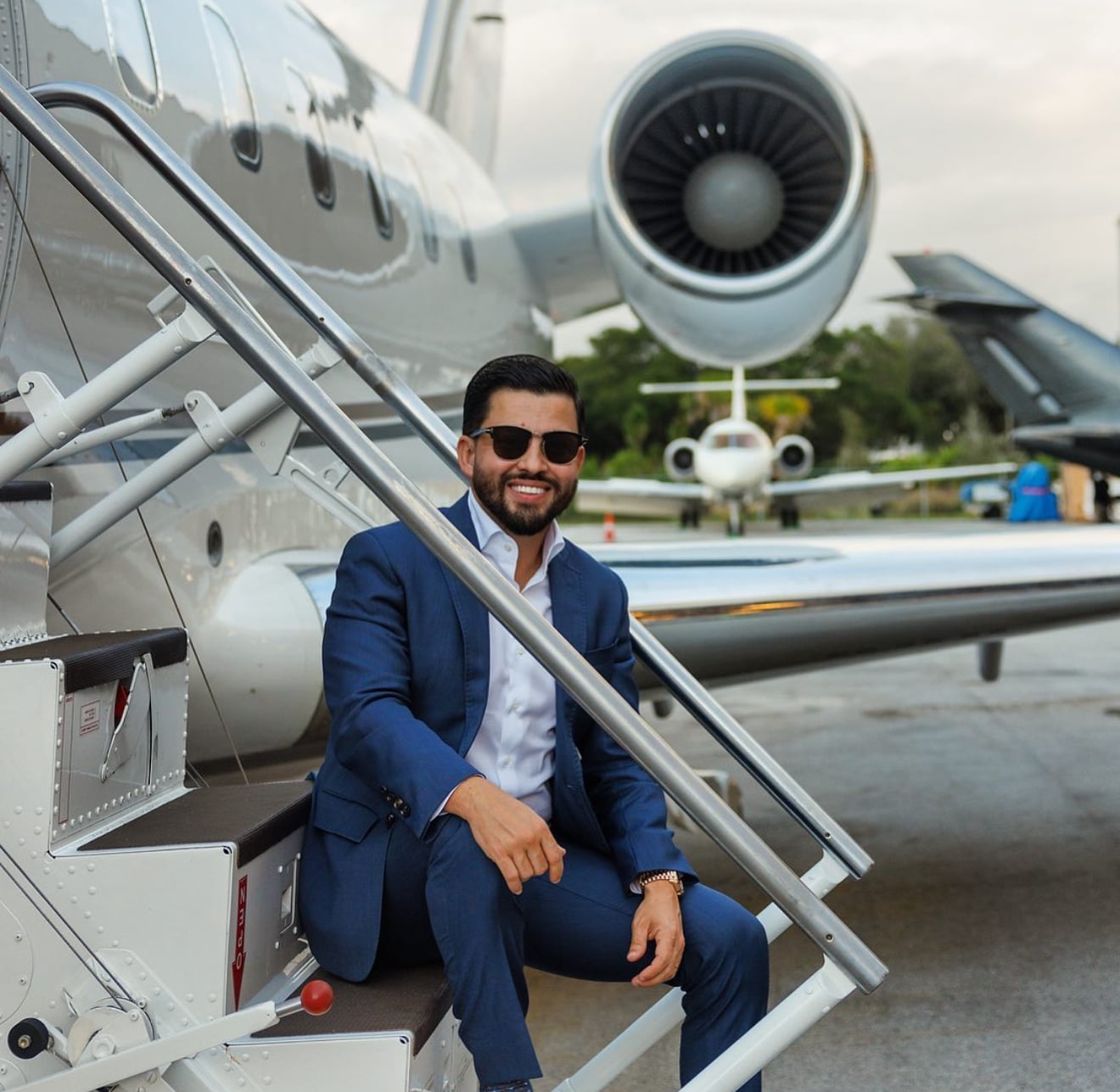Christian Alexander Delgado on private jet stairs